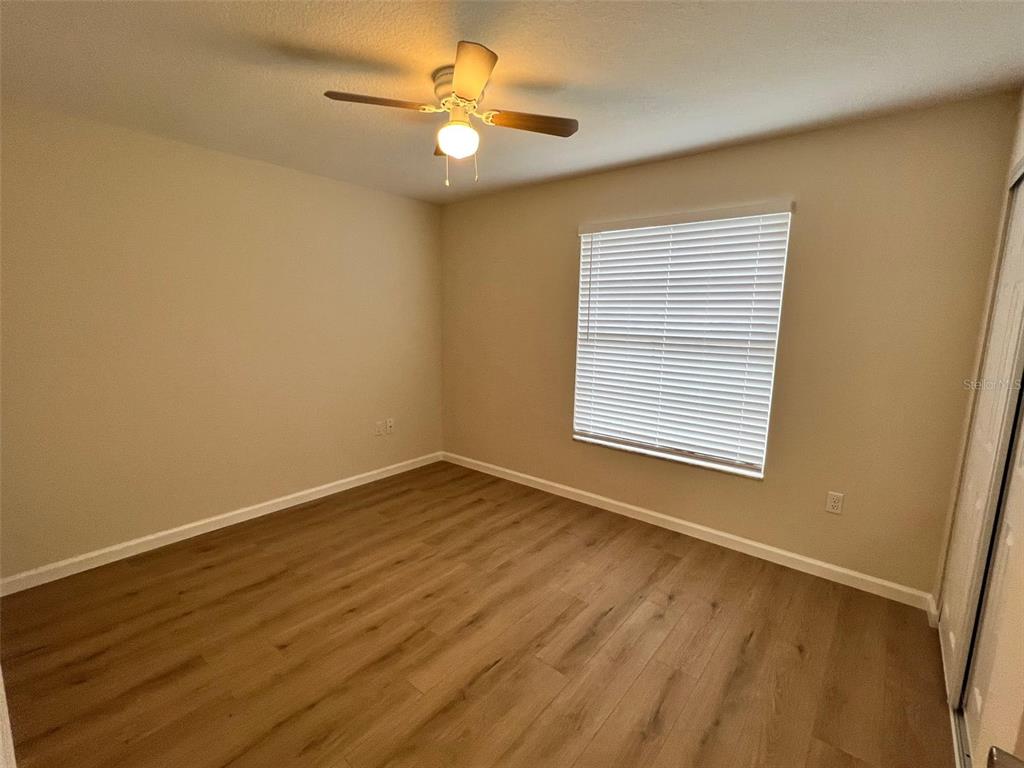 7224 Daggett Terrace New Port Richey, FL 34655 - Photo 12 of 14 a view of an empty room with wooden floor and a window