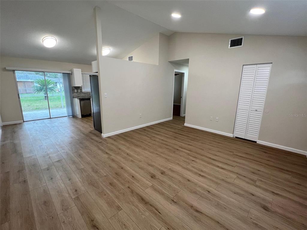 7224 Daggett Terrace New Port Richey, FL 34655 - Photo 4 of 14 an empty room with wooden floor and windows