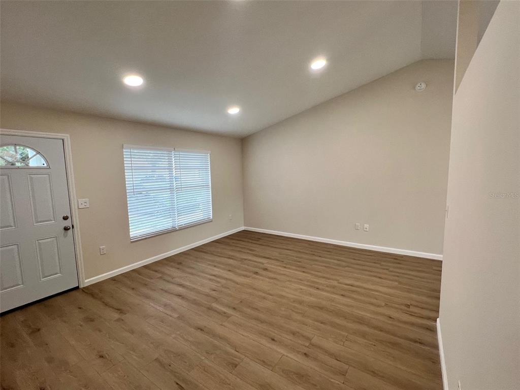 7224 Daggett Terrace New Port Richey, FL 34655 - Photo 6 of 14 an empty room with wooden floor and windows