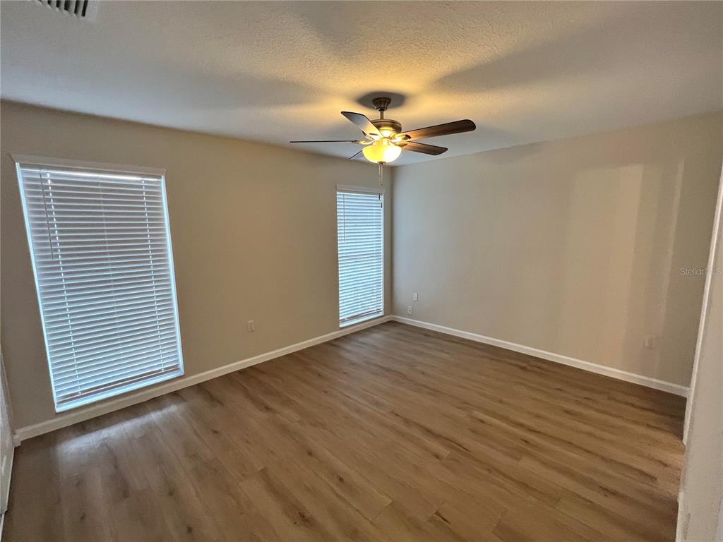 7224 Daggett Terrace New Port Richey, FL 34655 - Photo 7 of 14 a view of an empty room with a window and wooden floor