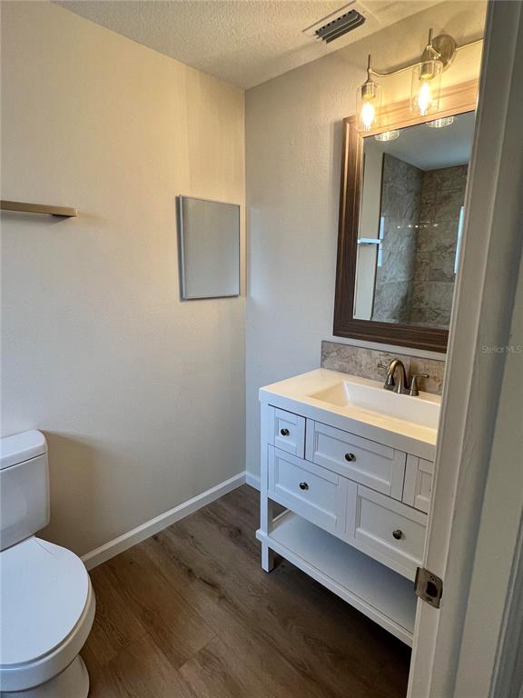 7224 Daggett Terrace New Port Richey, FL 34655 - Photo 9 of 14 a bathroom with a sink mirror vanity and toilet