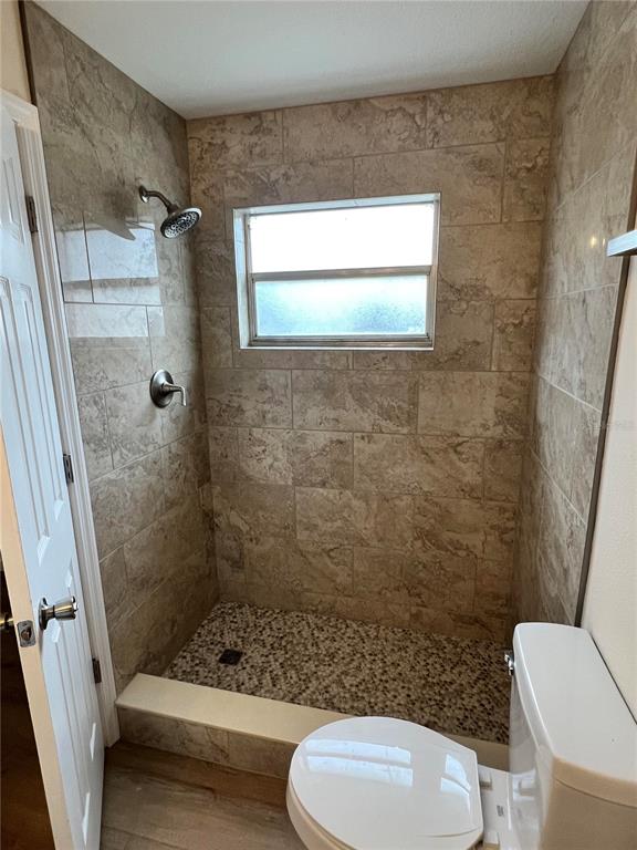 7224 Daggett Terrace New Port Richey, FL 34655 - Photo 10 of 14 a bathroom with a toilet and a shower