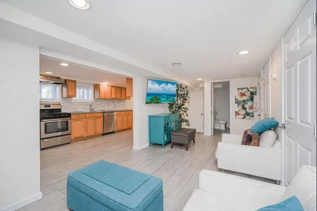 a living room with furniture and kitchen view