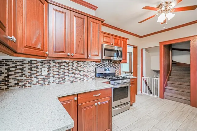 a kitchen with stainless steel appliances granite countertop a stove sink and cabinets
