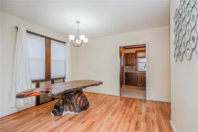 a view of a room with wooden floor and furniture