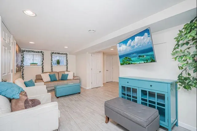 a living room with furniture and a potted plant