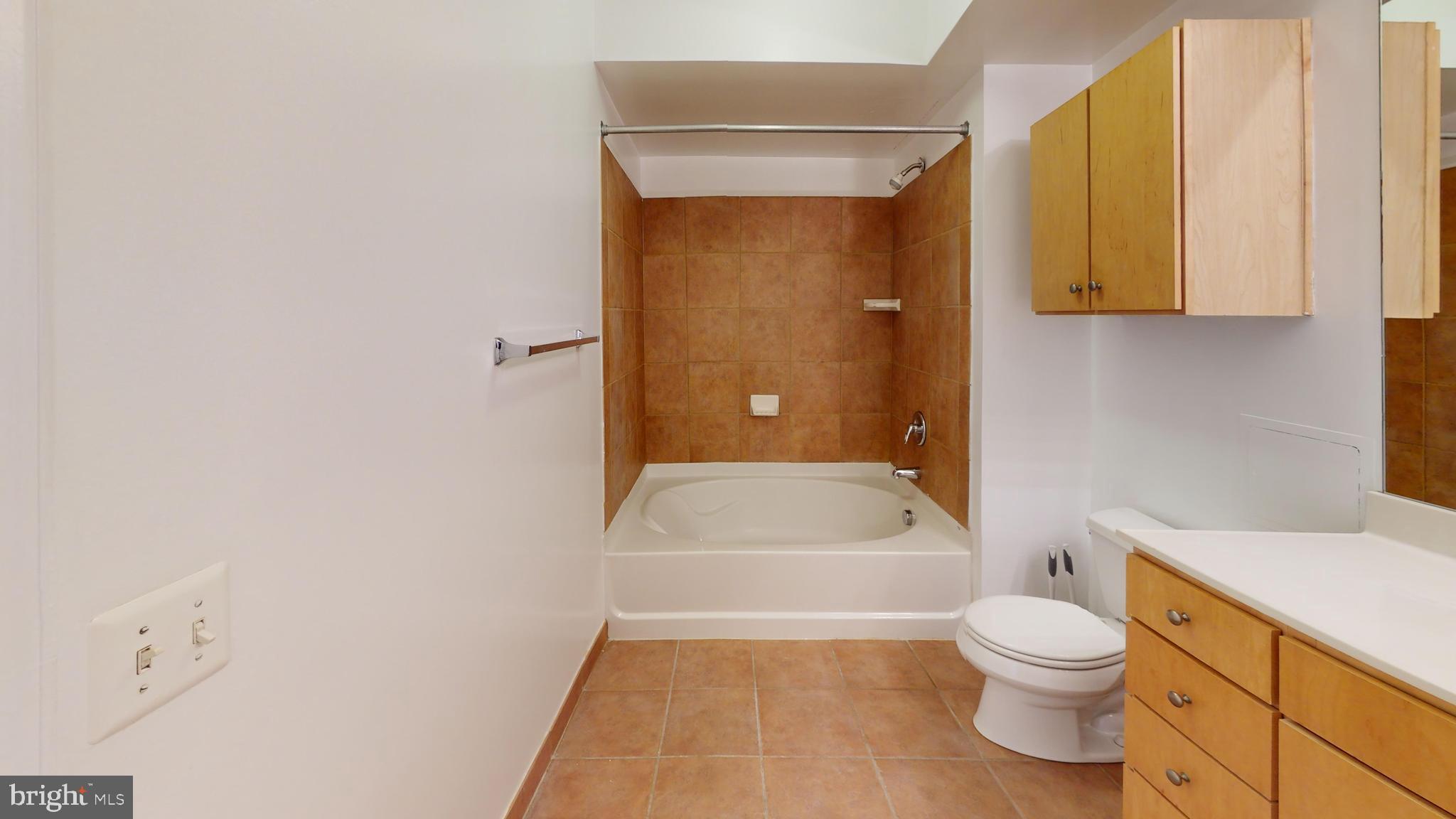631 D Street Northwest, Unit 931 Washington, DC 20004 - Photo 11 of 20 a bathroom with a toilet a sink and bathtub
