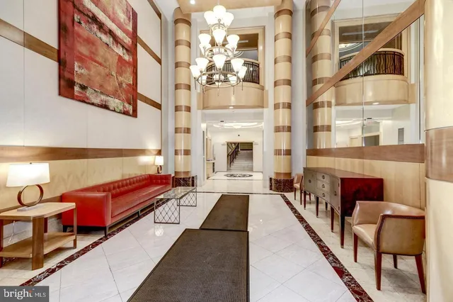a lobby with furniture and rug