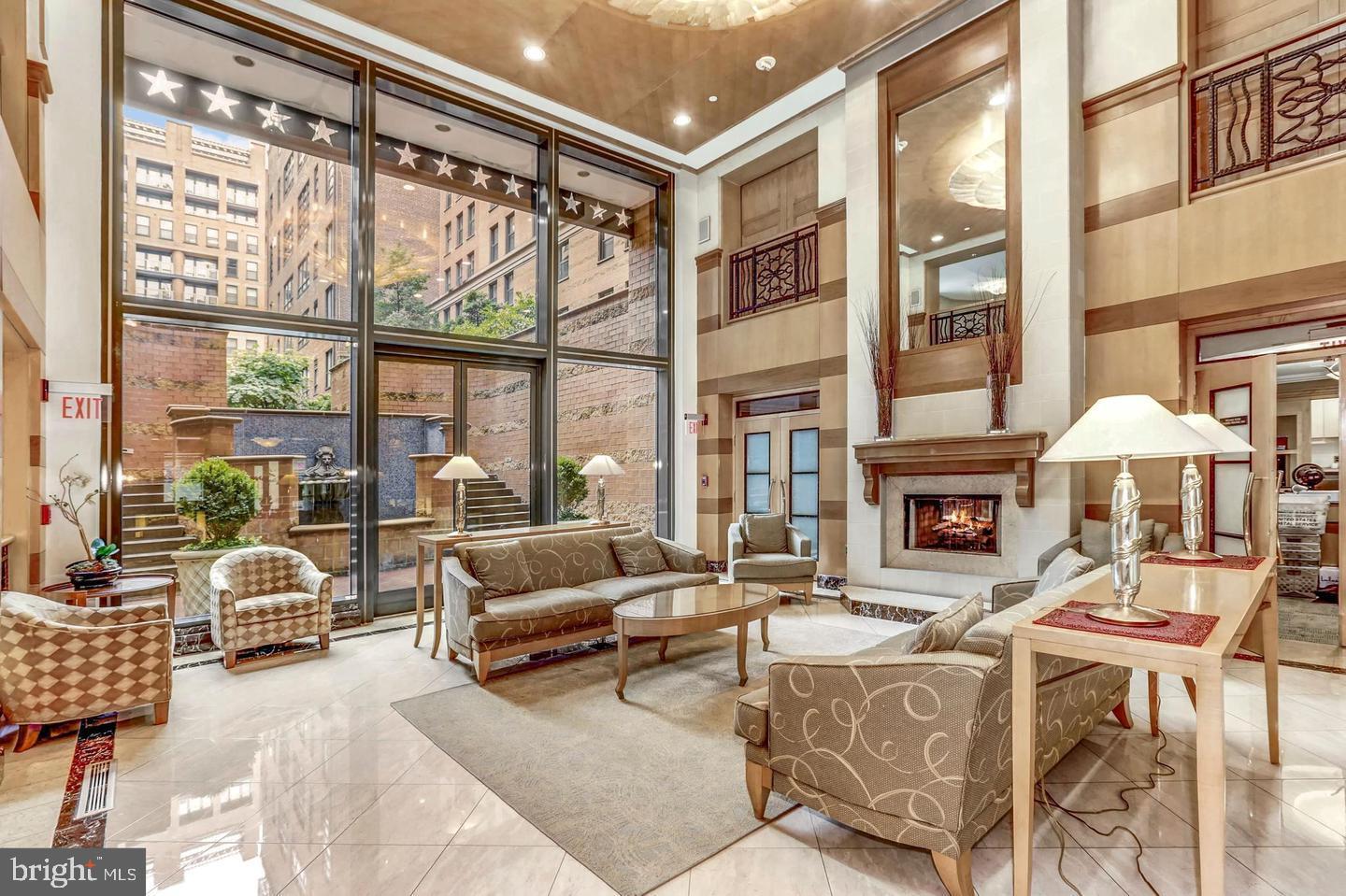 631 D Street Northwest, Unit 931 Washington, DC 20004 - Photo 18 of 20 a living room with furniture a fireplace and floor to ceiling windows