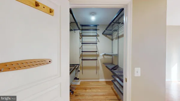 a view of hallway with stairs and wooden floor
