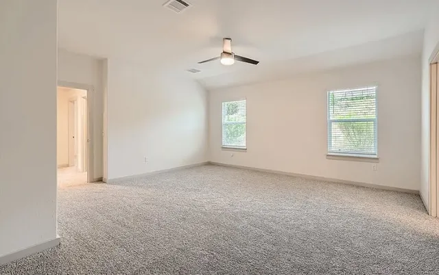 an empty room with windows and closet