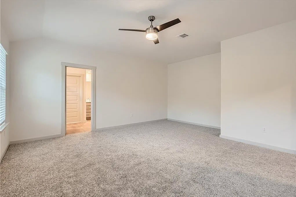 121 Merrick Road Georgetown, TX 78628 - Photo 18 of 29 an empty room with a ceiling fan and window