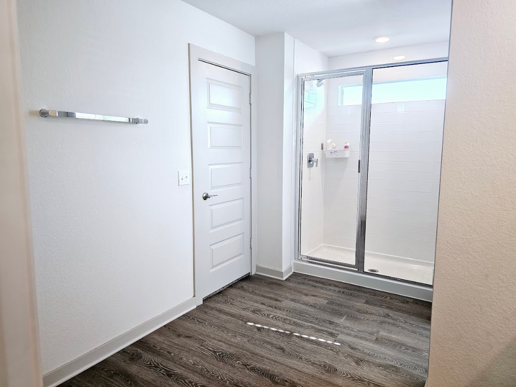 121 Merrick Road Georgetown, TX 78628 - Photo 19 of 29 an empty room with wooden floor and mirror