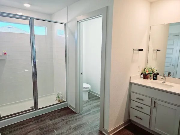 an empty room with wooden floor and mirror