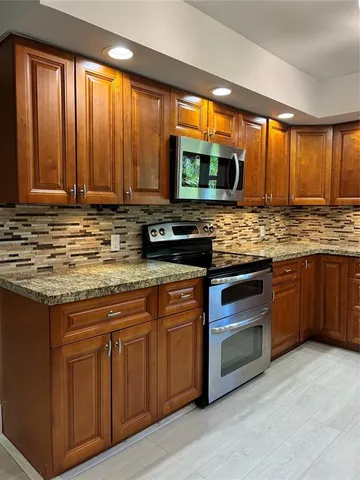 a living room with furniture and large windows