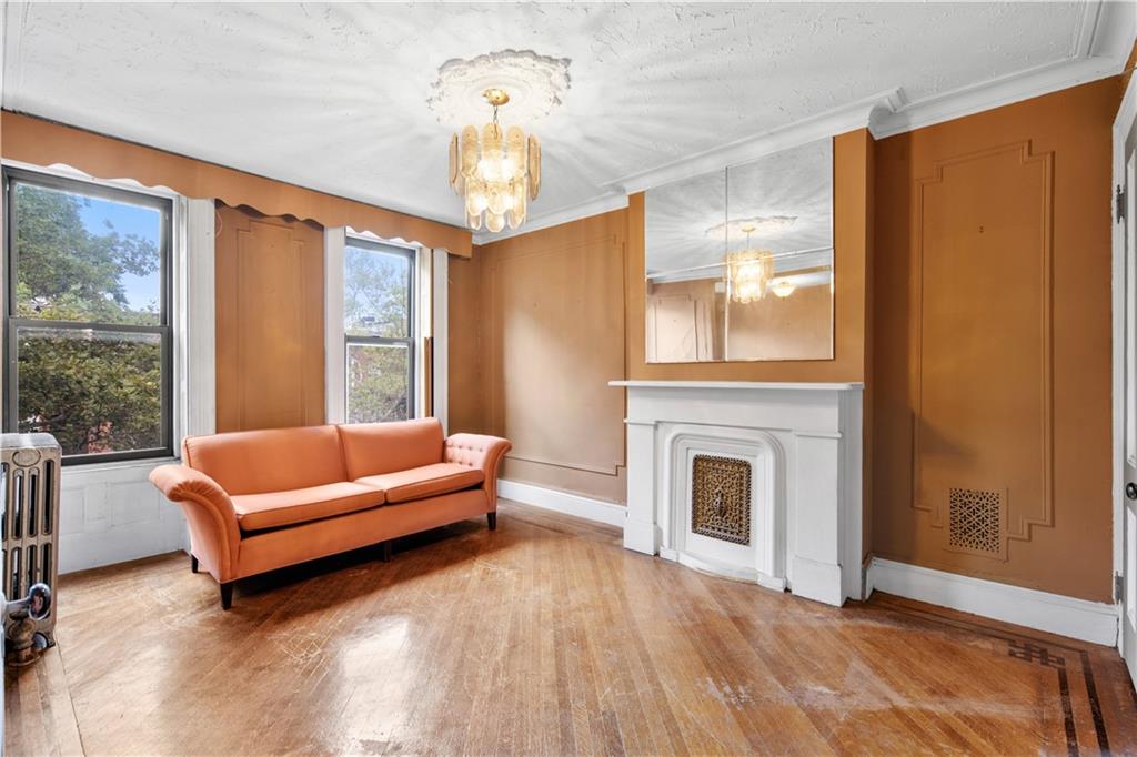 484 Decatur Street Brooklyn, NY 11233 - Photo 14 of 23 a living room with furniture and a fireplace