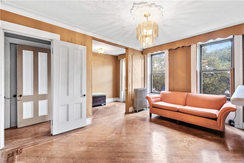 484 Decatur Street Brooklyn, NY 11233 - Photo 15 of 23 a living room with furniture and large windows