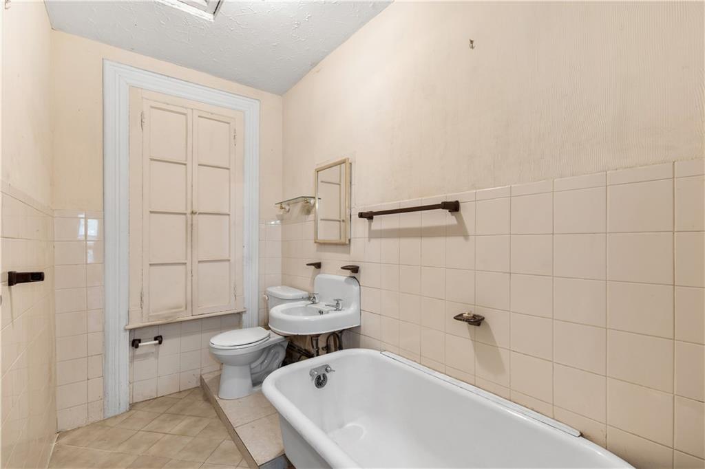 484 Decatur Street Brooklyn, NY 11233 - Photo 20 of 23 a bathroom with a sink and toilet