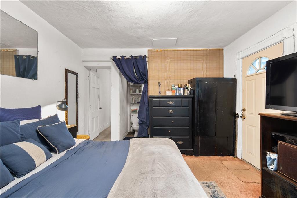 484 Decatur Street Brooklyn, NY 11233 - Photo 8 of 23 a living room with furniture and a flat screen tv