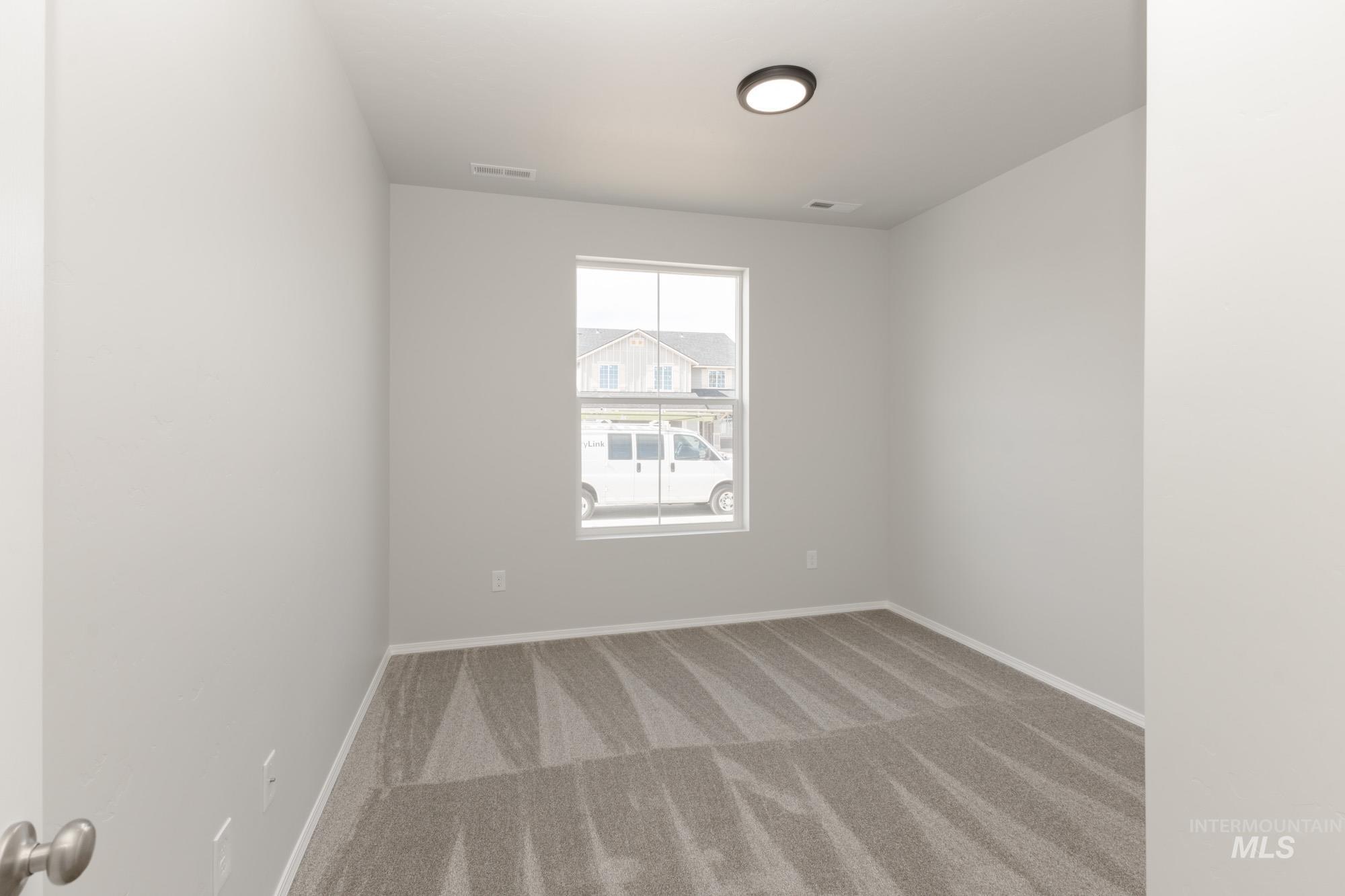 1459 Long Pond Street Middleton, ID 83644 - Photo 11 of 20 Carpeted spare room featuring baseboards
