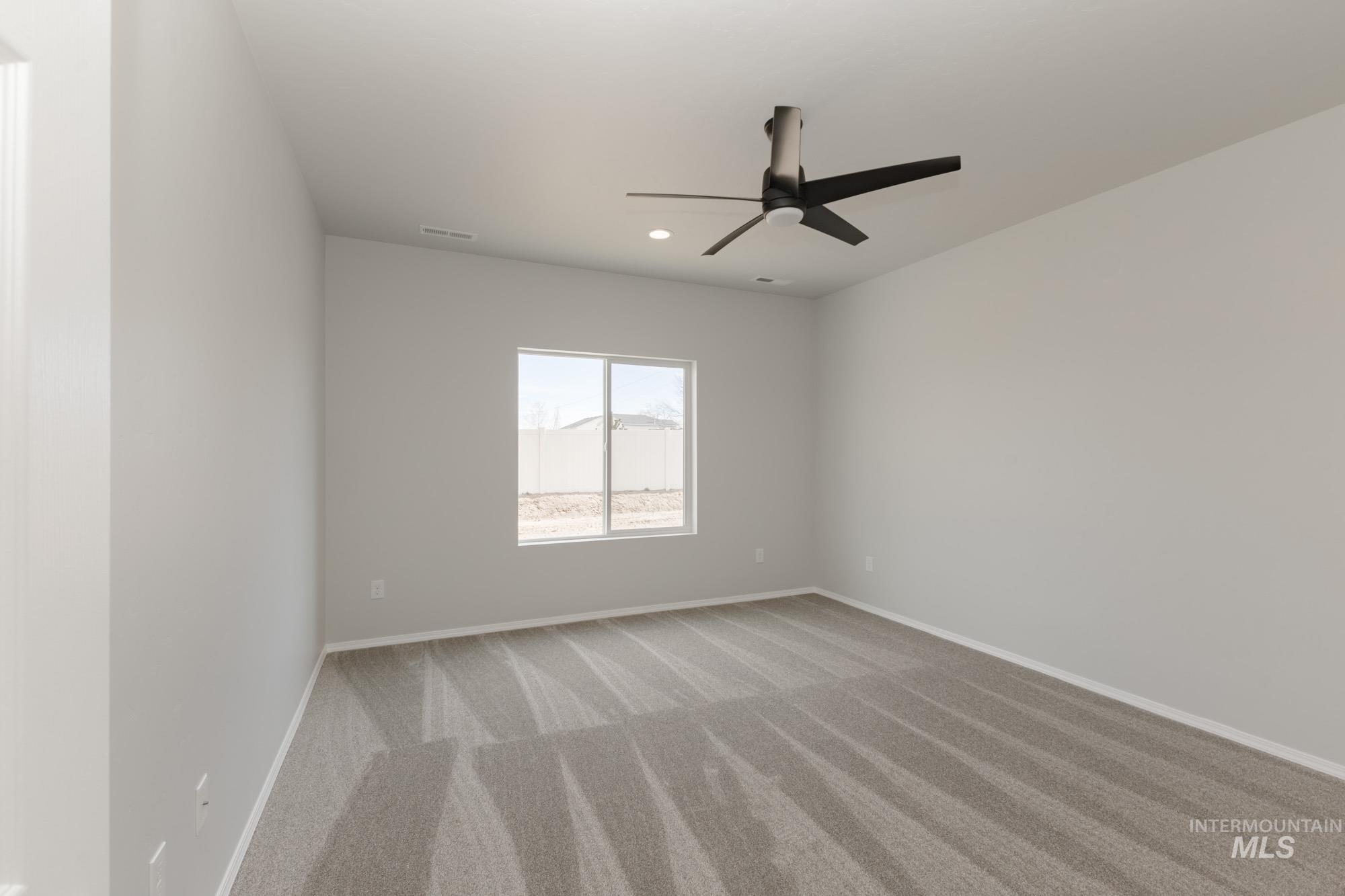 1459 Long Pond Street Middleton, ID 83644 - Photo 15 of 20 Spare room featuring light colored carpet, ceiling fan, and recessed lighting