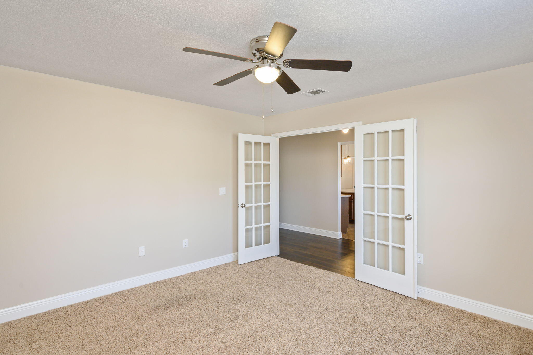 4521 Hermosa Road Crestview, FL 32539 - Photo 27 of 33 a view of an empty room with a ceiling fan