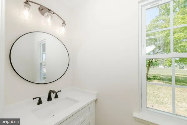 a bathroom with a mirror and a sink