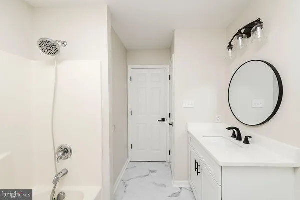 a bathroom with a sink and mirror
