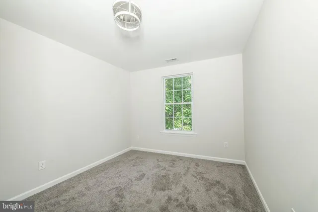an empty room with a empty space and a window