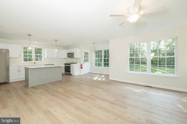 a view of an empty room with window and cabinet