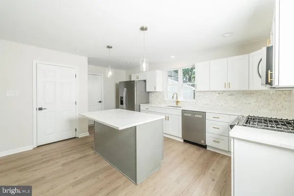 a kitchen with a cabinets and wooden floor