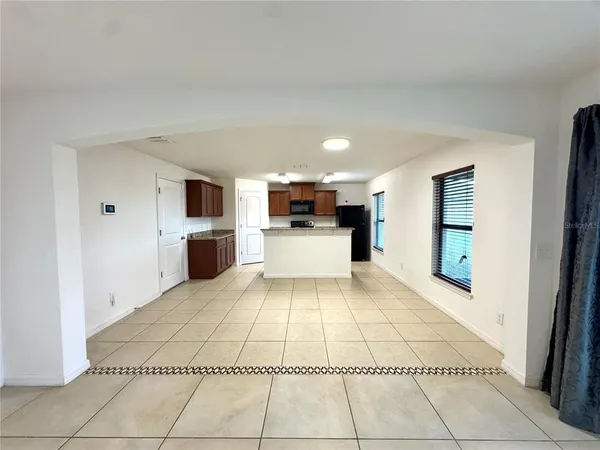 a large white kitchen with granite countertop a sink and dishwasher a stove with white countertops