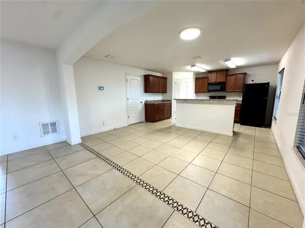 a view of a kitchen with a sink and a refrigerator