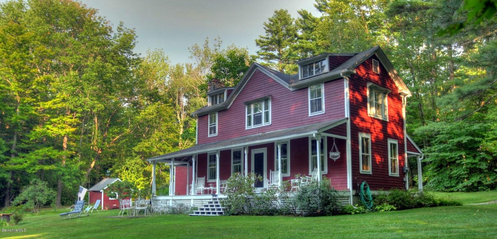 585 Main Road Monterey, MA 01245 - Photo 1 of 27 a view of a brick house with plants and large trees