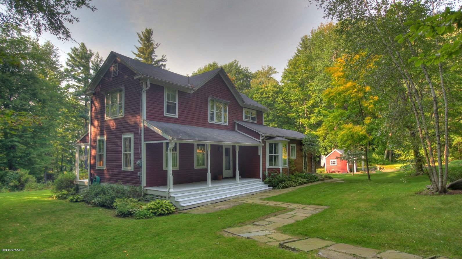 585 Main Road Monterey, MA 01245 - Photo 2 of 27 a front view of a house with garden
