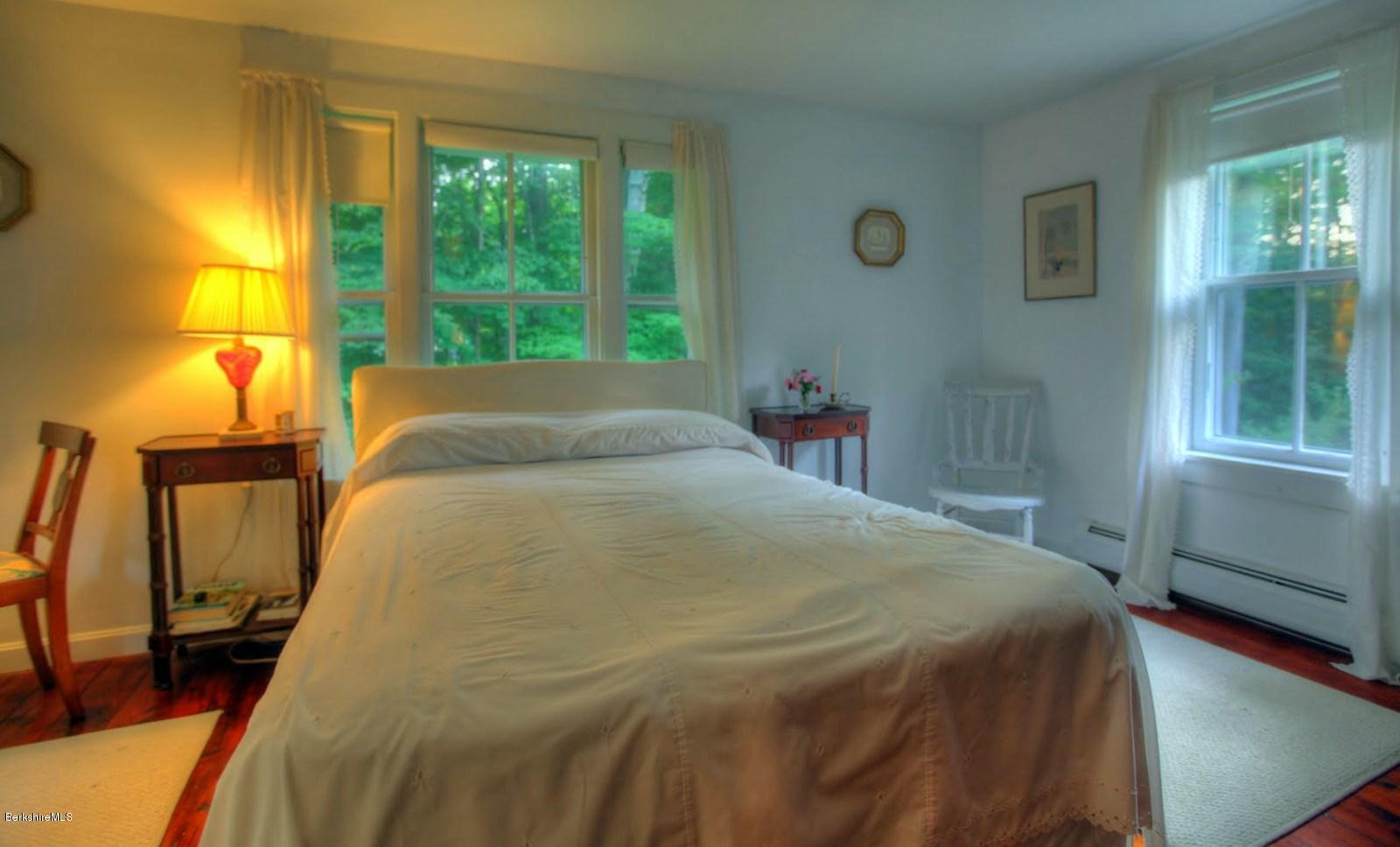 585 Main Road Monterey, MA 01245 - Photo 18 of 27 a bed sitting in a bedroom next to a window