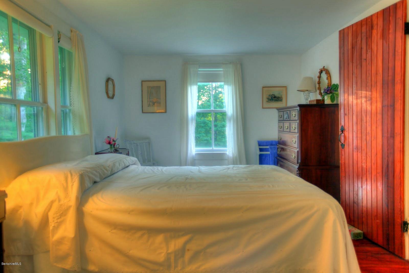 585 Main Road Monterey, MA 01245 - Photo 19 of 27 a bed sitting in a bedroom next to a window