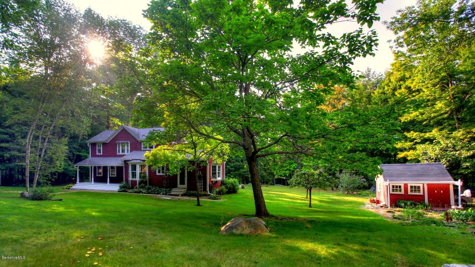 585 Main Road Monterey, MA 01245 - Photo 21 of 27 a view of a big yard with large trees and a big yard