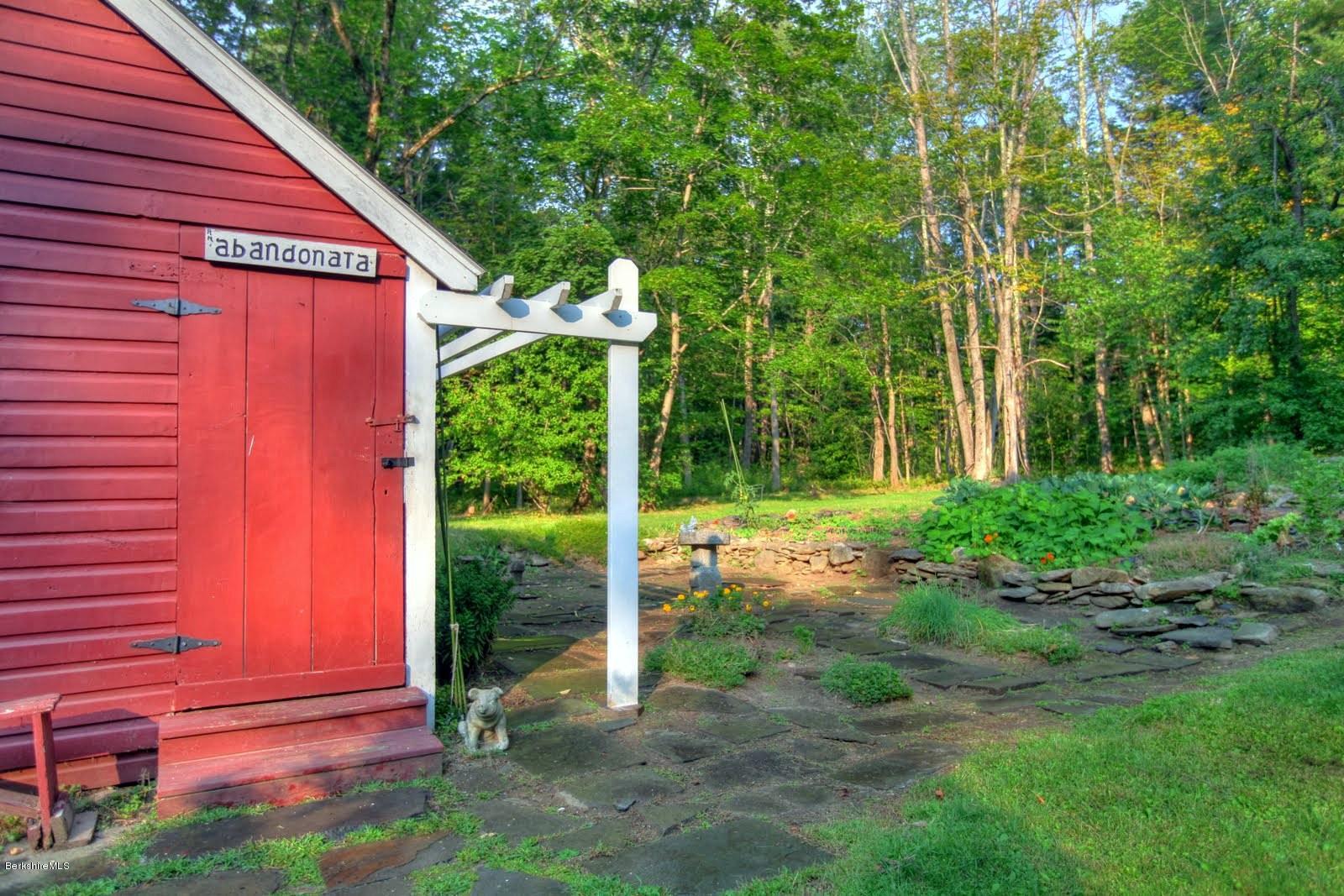 585 Main Road Monterey, MA 01245 - Photo 26 of 27 a backyard of a house with plants and outdoor seating