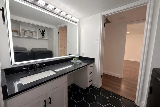 a bathroom with a sink and a mirror