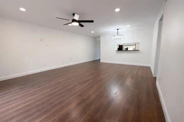a view of a kitchen with a sink and wooden floor
