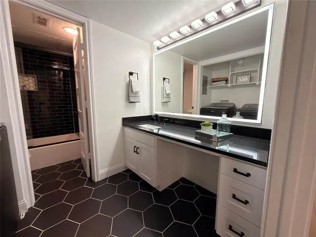 a bathroom with a double vanity sink a mirror and a shower