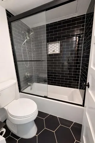 a bathroom with a toilet and a shower