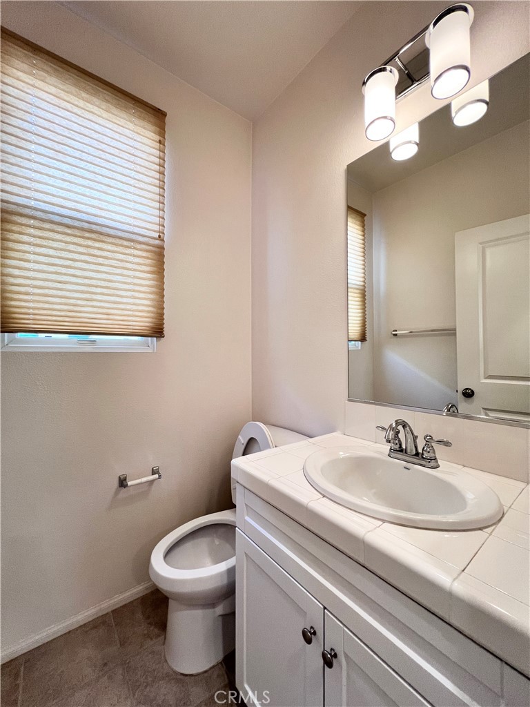 58 South 5th Street, Unit F Alhambra, CA 91801 - Photo 12 of 24 a bathroom with a sink a toilet and a mirror