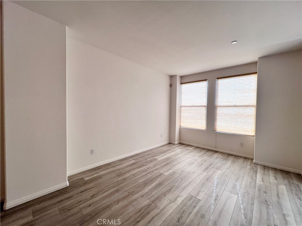 58 South 5th Street, Unit F Alhambra, CA 91801 - Photo 13 of 24 an empty room with wooden floor and windows