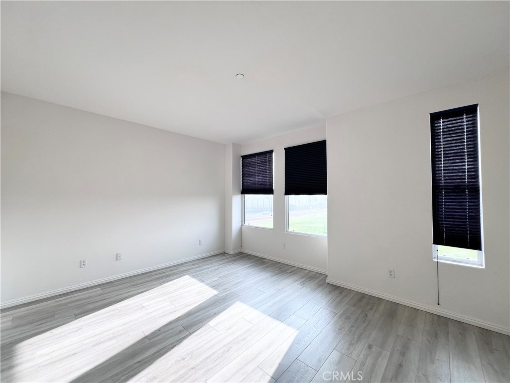 58 South 5th Street, Unit F Alhambra, CA 91801 - Photo 14 of 24 a view of an empty room with wooden floor and windows