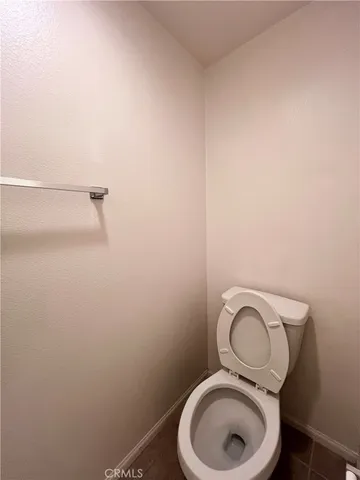 a white toilet sitting next to a shower