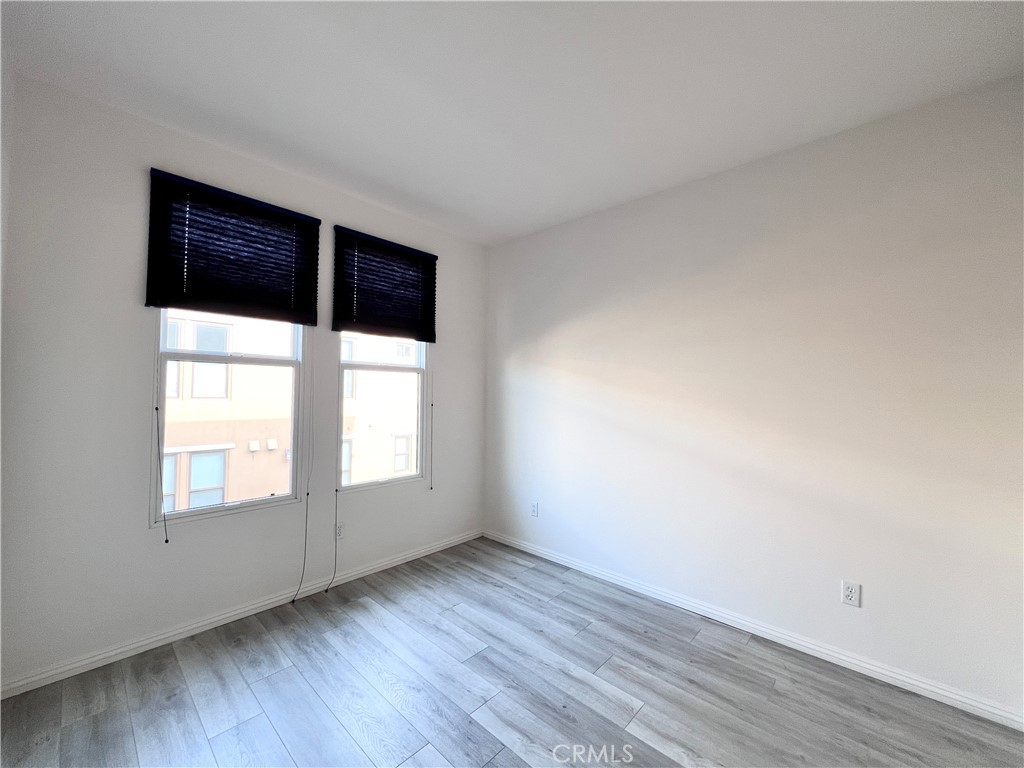 58 South 5th Street, Unit F Alhambra, CA 91801 - Photo 19 of 24 an empty room with wooden floor and windows
