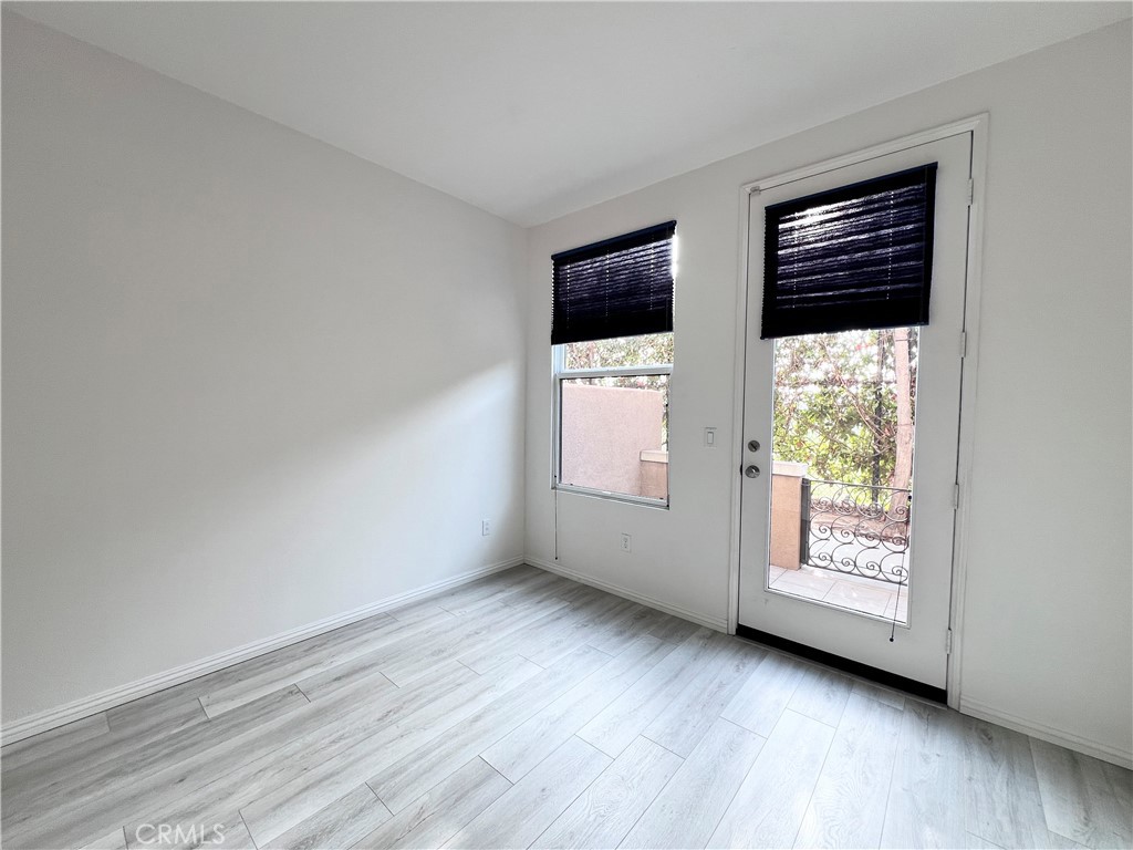58 South 5th Street, Unit F Alhambra, CA 91801 - Photo 3 of 24 a view of an empty room with a window and wooden floor
