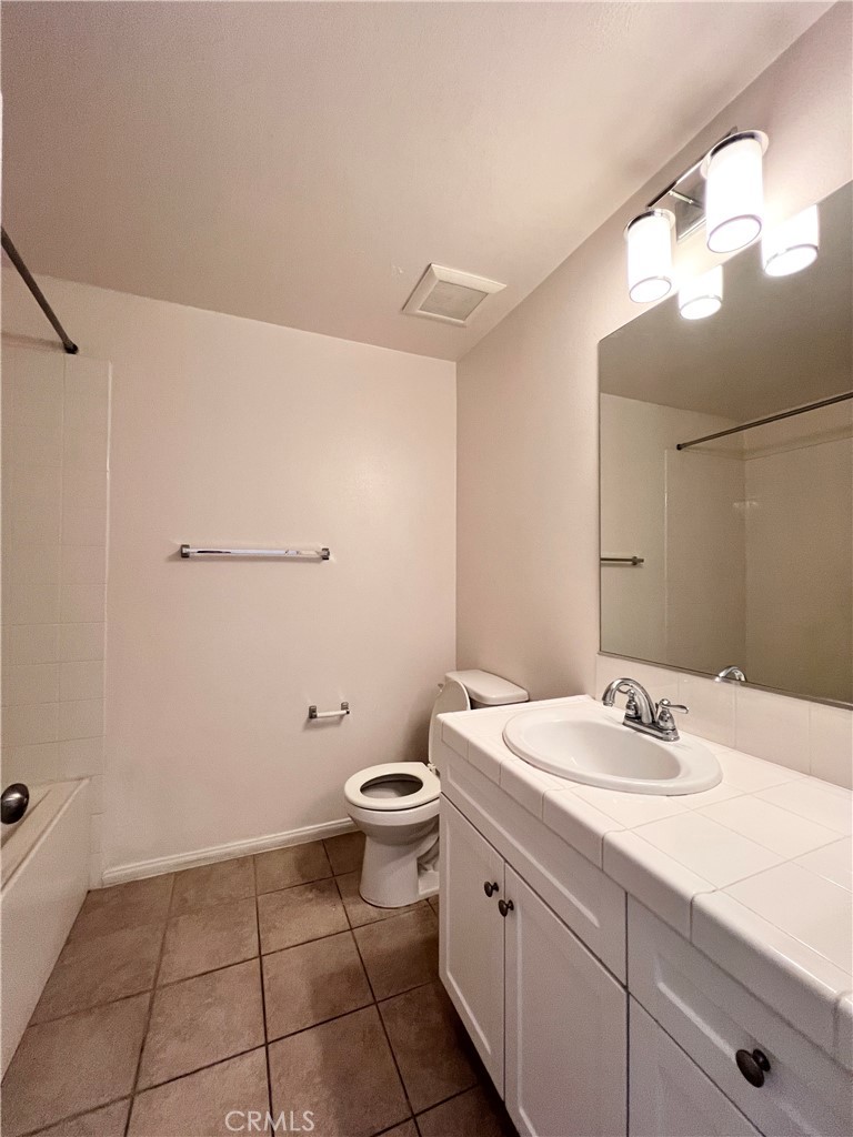 58 South 5th Street, Unit F Alhambra, CA 91801 - Photo 6 of 24 a bathroom with a sink a toilet and a mirror